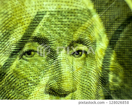 Green face of George Washington on a crumpled dollar bill in close up macro in grayscale 128026858