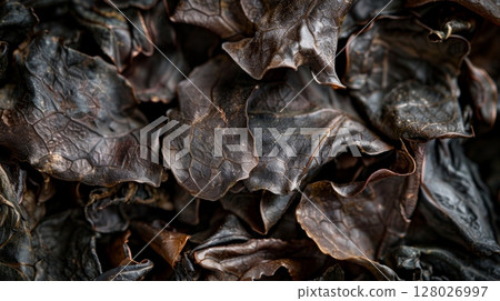 A detailed shot of the tightly rolled oolong tea leaves showcasing the smooth surface and tight curls of this unique type of tea 128026997