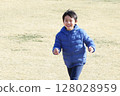 Active and happy smiling cheerful child running in the park Asian Japanese boy 128028959