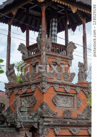 Detailed stone carvings adorn traditional Balinese temple architecture 128029198