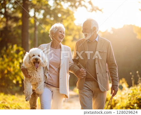 Senior couple and poodle walking surrounded by greenery 128029624