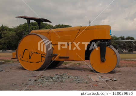 Large yellow road roller machine used for ground compaction and construction Large yellow road roller machine used for ground compaction and construction 128029650