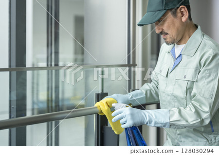 Building cleaning image: Senior cleaning staff wiping down handrails Building cleaning image: Senior cleaning staff wiping down handrails 128030294