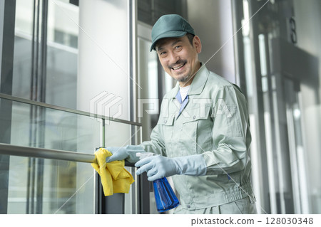 Building cleaning image Senior cleaning staff smiling at the camera 128030348