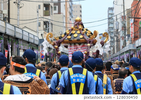 A police officer guarding the procession of the portable shrine A police officer guarding the procession of the portable shrine 128030450