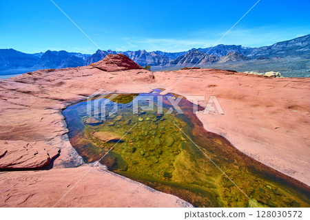 Red Rock Canyon Desert Pool with Mountains Midday Eye-Level View Red Rock Canyon Desert Pool with Mountains Midday Eye-Level View 128030572