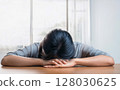 A woman lying on her desk 128030625