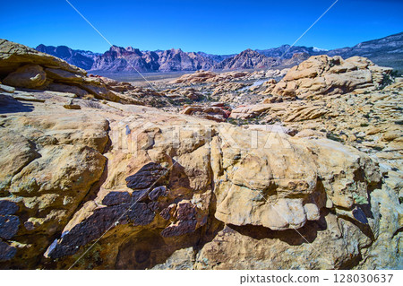 Red Rock Canyon Sandstone Formations with Majestic Mountains in Daylight 128030637