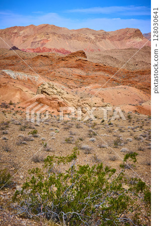 Rugged Desert Hills and Vibrant Sedimentary Layers Under Clear Sky Eye-Level 128030641