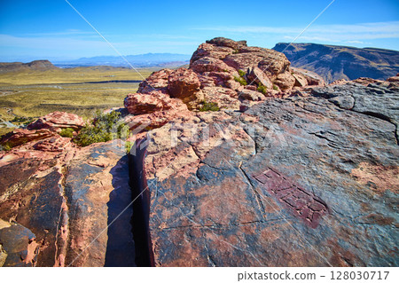 Red Rock Canyon Desert Landscape with Historic Carvings and Vast Horizon Red Rock Canyon Desert Landscape with Historic Carvings and Vast Horizon 128030717