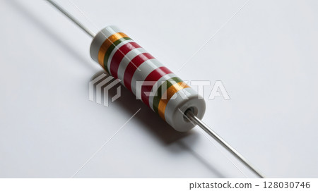 Close-up shot of a resistor with colored stripes and silver wires on white background Close-up shot of a resistor with colored stripes and silver wires on white background 128030746