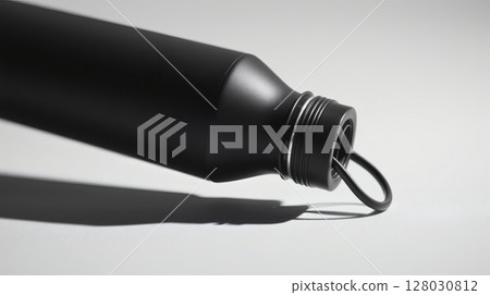 Close-up shot of a sleek black water bottle with a minimalist design against a white background. 128030812