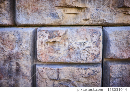 Weathered Stone Wall Texture Close-Up from Eye Level Weathered Stone Wall Texture Close-Up from Eye Level 128031044
