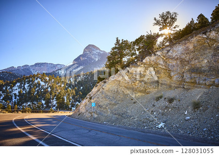 Snow-Dusted Mt Charleston with Winding Road at Golden Hour Eye Level Snow-Dusted Mt Charleston with Winding Road at Golden Hour Eye Level 128031055