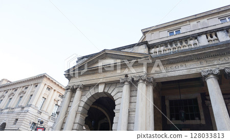 Verona, Italy Latin inscription on the portal of Piazza Bra, built in 1929 during the Fascist Era. Neoclassical facade with Ionic columns in central Verona, Veneto. 128033813