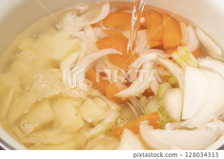 Steps for making vegetable consommé soup: Chop and simmer vegetables 128034313