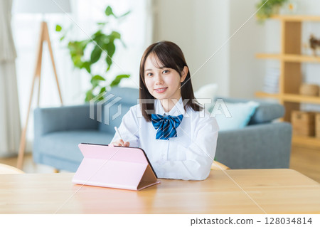 Female high school student studying on tablet Female high school student studying on tablet 128034814