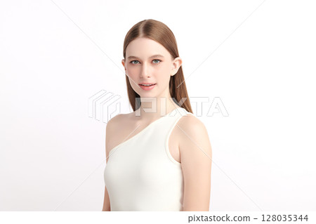 A beautiful young woman with clean, fresh skin against a white background. Skincare, facial treatment, cosmetology, beauty, and spa. An elegant portrait of an woman. 128035344