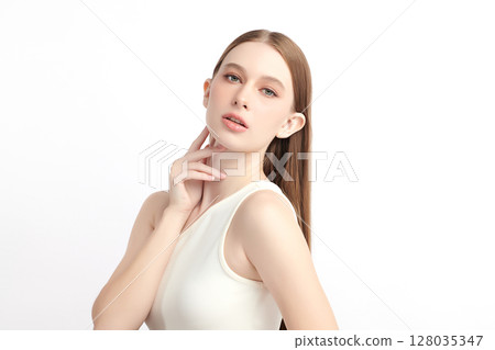 A beautiful young woman with clean, fresh skin against a white background. Skincare, facial treatment, cosmetology, beauty, and spa. An elegant portrait of an woman. A beautiful young woman with clean, fresh skin against a white background. Skincare, facial treatment, cosmetology, beauty, and spa. An elegant portrait of an woman. 128035347