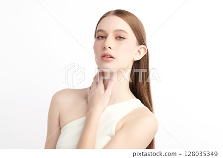 A beautiful young woman with clean, fresh skin against a white background. Skincare, facial treatment, cosmetology, beauty, and spa. An elegant portrait of an woman. 128035349