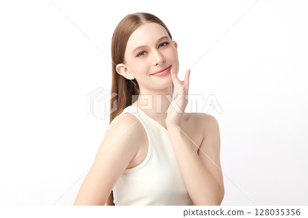A beautiful young woman with clean, fresh skin against a white background. Skincare, facial treatment, cosmetology, beauty, and spa. An elegant portrait of an woman. 128035356