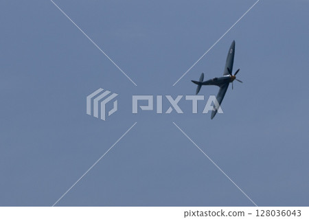 Spitfire plane in flight on sunny day. High quality photo Spitfire plane in flight on sunny day. High quality photo 128036043