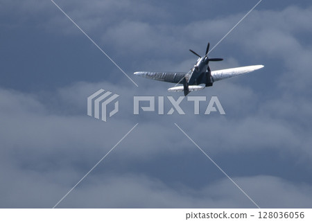 Spitfire plane in flight on sunny day. High quality photo Spitfire plane in flight on sunny day. High quality photo 128036056