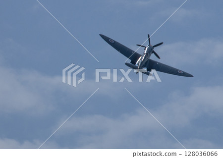 Spitfire plane in flight on sunny day. High quality photo Spitfire plane in flight on sunny day. High quality photo 128036066
