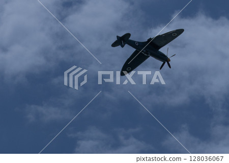 Spitfire plane in flight on sunny day. High quality photo Spitfire plane in flight on sunny day. High quality photo 128036067