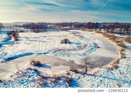 Aerial view of the countryside and frozen winding brook on a sunny day. Beautiful nature landscape Aerial view of the countryside and frozen winding brook on a sunny day. Beautiful nature landscape 128036115