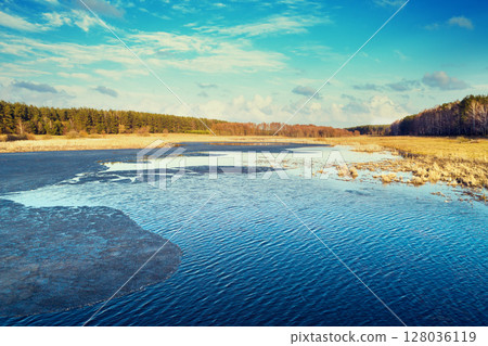Aerial view of countryside and frozen stream on a sunny spring day. Beautiful natural landscape Aerial view of countryside and frozen stream on a sunny spring day. Beautiful natural landscape 128036119