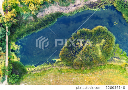 A winding stream flows across the field. View from above 128036148