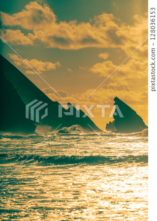 Rocky seascape in the evening. Sunset over the sea. Natural landscape. Vertical banner Rocky seascape in the evening. Sunset over the sea. Natural landscape. Vertical banner 128036153