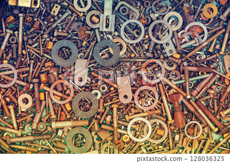 Abstract grunge colorful metal background made of fastening bolts, screws, nuts Abstract grunge colorful metal background made of fastening bolts, screws, nuts 128036325