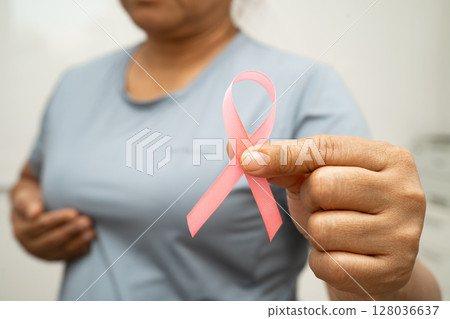 Breast cancer, pink ribbon at Asian senior lady for supporting awareness, symbol of World Breast Cancer Day. Breast cancer, pink ribbon at Asian senior lady for supporting awareness, symbol of World Breast Cancer Day. 128036637