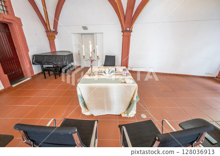 Luxurious wedding setup with round tables, stylish chairs, and beautiful floral decorations creating romantic atmosphere 128036913