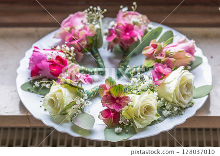 Small stylish boutonnieres on white marble plate, flat lay colorful many groom Small stylish boutonnieres on white marble plate, flat lay colorful many groom 128037010