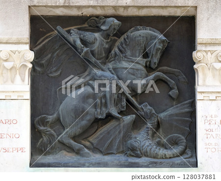 Saint George slaying the dragon relief on the building in the city of Lucca in Tuscany, Italy Saint George slaying the dragon relief on the building in the city of Lucca in Tuscany, Italy 128037881