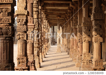 Columns with stone carving in courtyard of Quwwat-Ul-Islam mosque, Qutub Minar complex, Delhi, India Columns with stone carving in courtyard of Quwwat-Ul-Islam mosque, Qutub Minar complex, Delhi, India 128038049