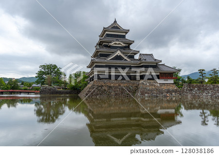 Historic Matsumoto Castle reflected in calm waters, Japan 128038186