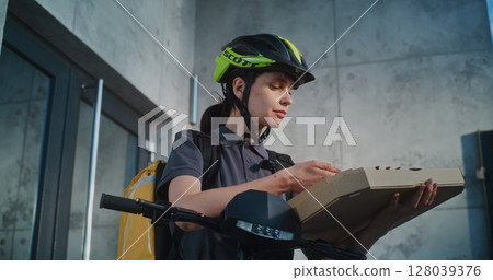 Delivery Woman Notifying Client about Successful Food Delivery Chatting on Phone Delivery Woman Notifying Client about Successful Food Delivery Chatting on Phone 128039376