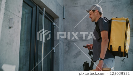 Delivery Man Brining Paper Bag with Food for Businesswoman Working in Office Delivery Man Brining Paper Bag with Food for Businesswoman Working in Office 128039521