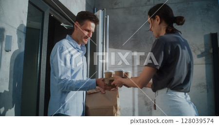 Delivery Woman Brining Coffee and Restaurant Food in Brown Paper Bag for Businessman 128039574