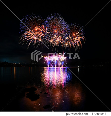 Beautiful colorful fireworks with reflections in water. Brno dam, the city of Brno-Europe. International Fireworks Competition. Beautiful colorful fireworks with reflections in water. Brno dam, the city of Brno-Europe. International Fireworks Competition. 128040310