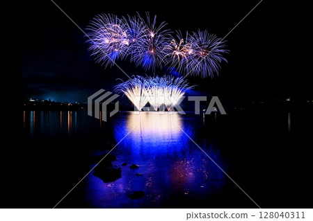 Beautiful colorful fireworks with reflections in water. Brno dam, the city of Brno-Europe. International Fireworks Competition. Beautiful colorful fireworks with reflections in water. Brno dam, the city of Brno-Europe. International Fireworks Competition. 128040311