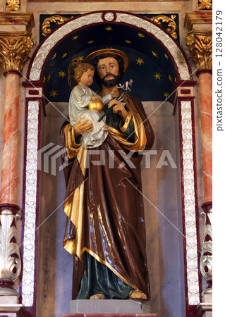 Saint Joseph holding baby Jesus, statue on the altar of Saint Joseph in the Church of Saint Barbara in Rude, Croatia Saint Joseph holding baby Jesus, statue on the altar of Saint Joseph in the Church of Saint Barbara in Rude, Croatia 128042179