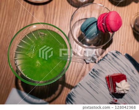 Green cocktail on a wooden table Green cocktail on a wooden table 128042368