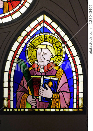Saint Deacon the Martyr depicted in the stained-glass window designed by Italian Renaissance painter Giotto di Bondone dated from the early 14th century in the Basilica di Santa Croce in Florence 128043405