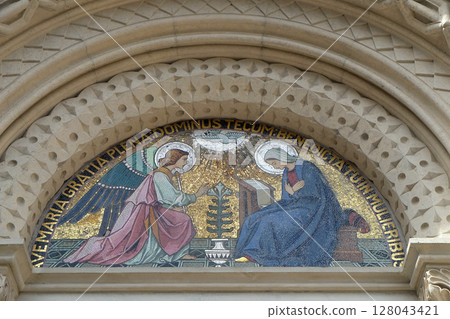 Annunciation, lunette above the entrance to the Franciscan Church of St. Mary Mother of Mercy in Maribor, Slovenia 128043421
