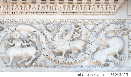 Bass relief on the Portal of San Michele in Foro Church in Lucca, Italy Bass relief on the Portal of San Michele in Foro Church in Lucca, Italy 128043455